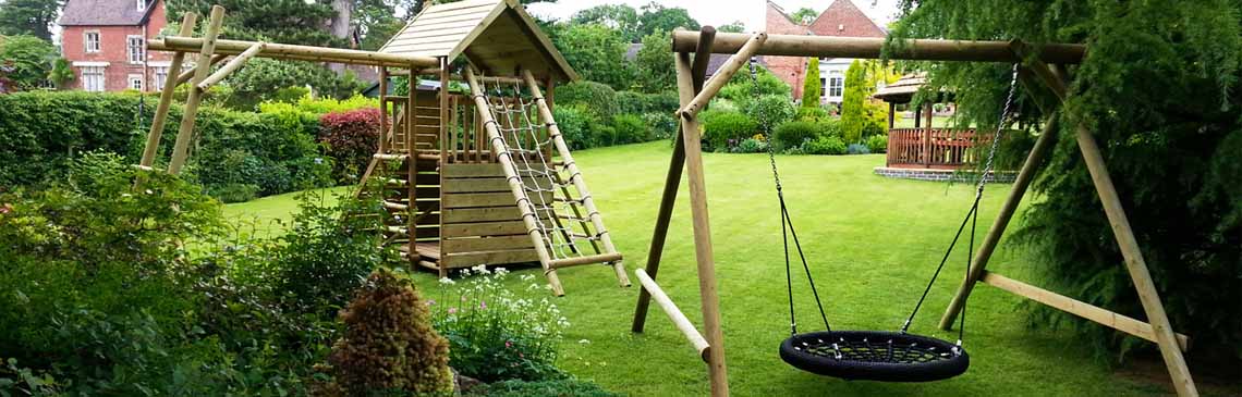 Garden play fort and family basket swing in lovely English garden